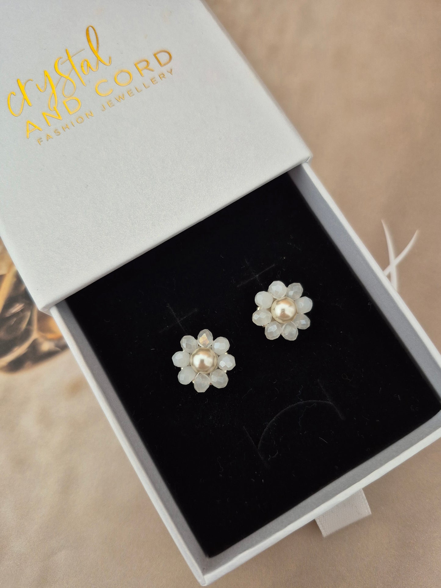 Elara Dusk - flower shaped stud earrings with glass beads and a pearl center
