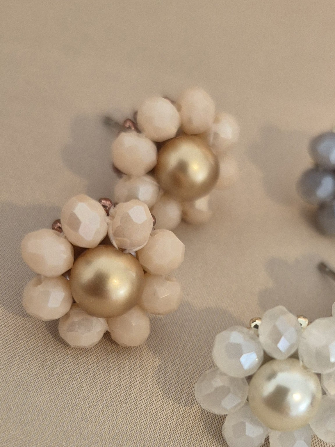 Elara Dusk - flower shaped stud earrings with glass beads and a pearl center