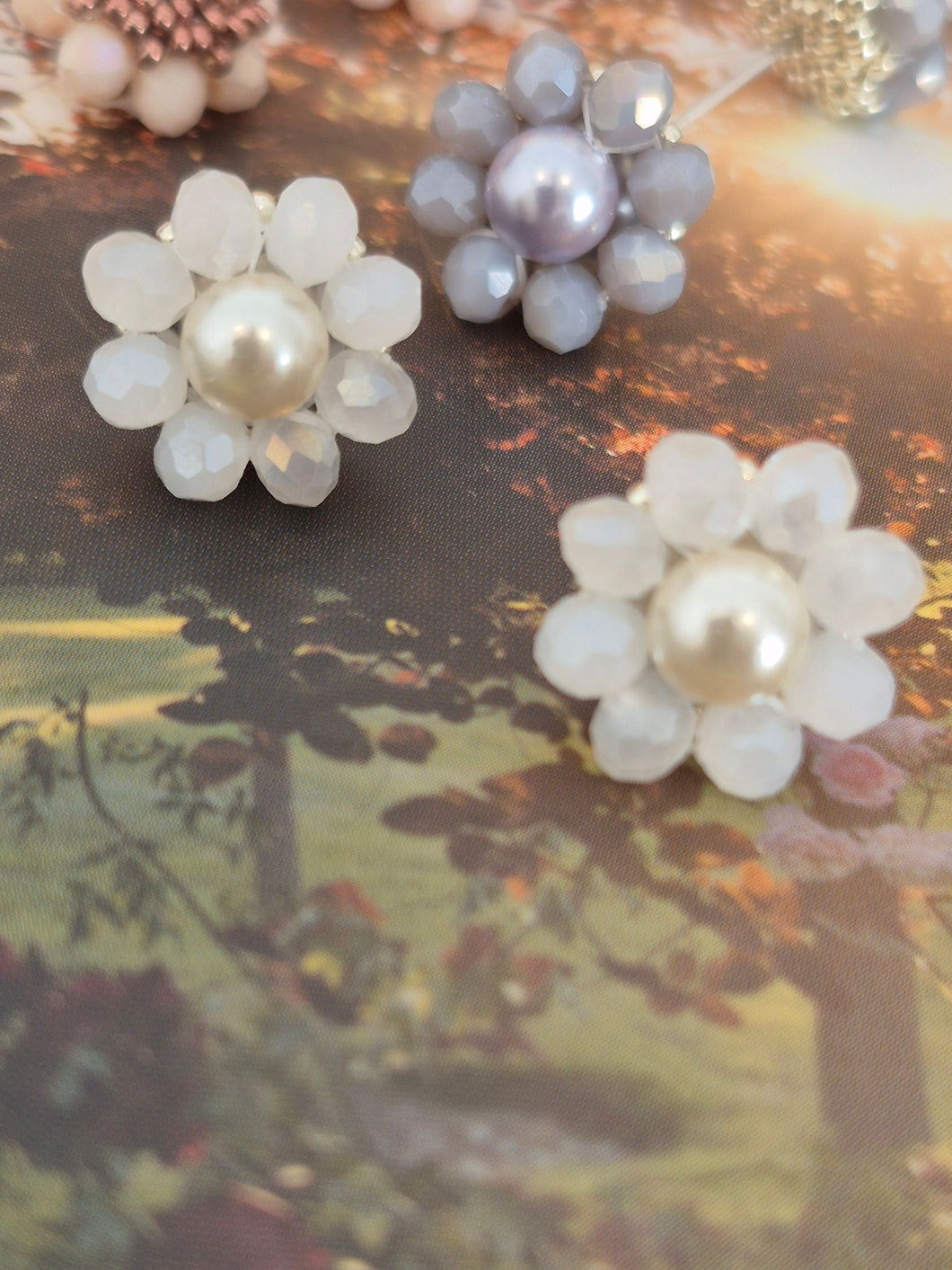 Elara Dusk - flower shaped stud earrings with glass beads and a pearl center