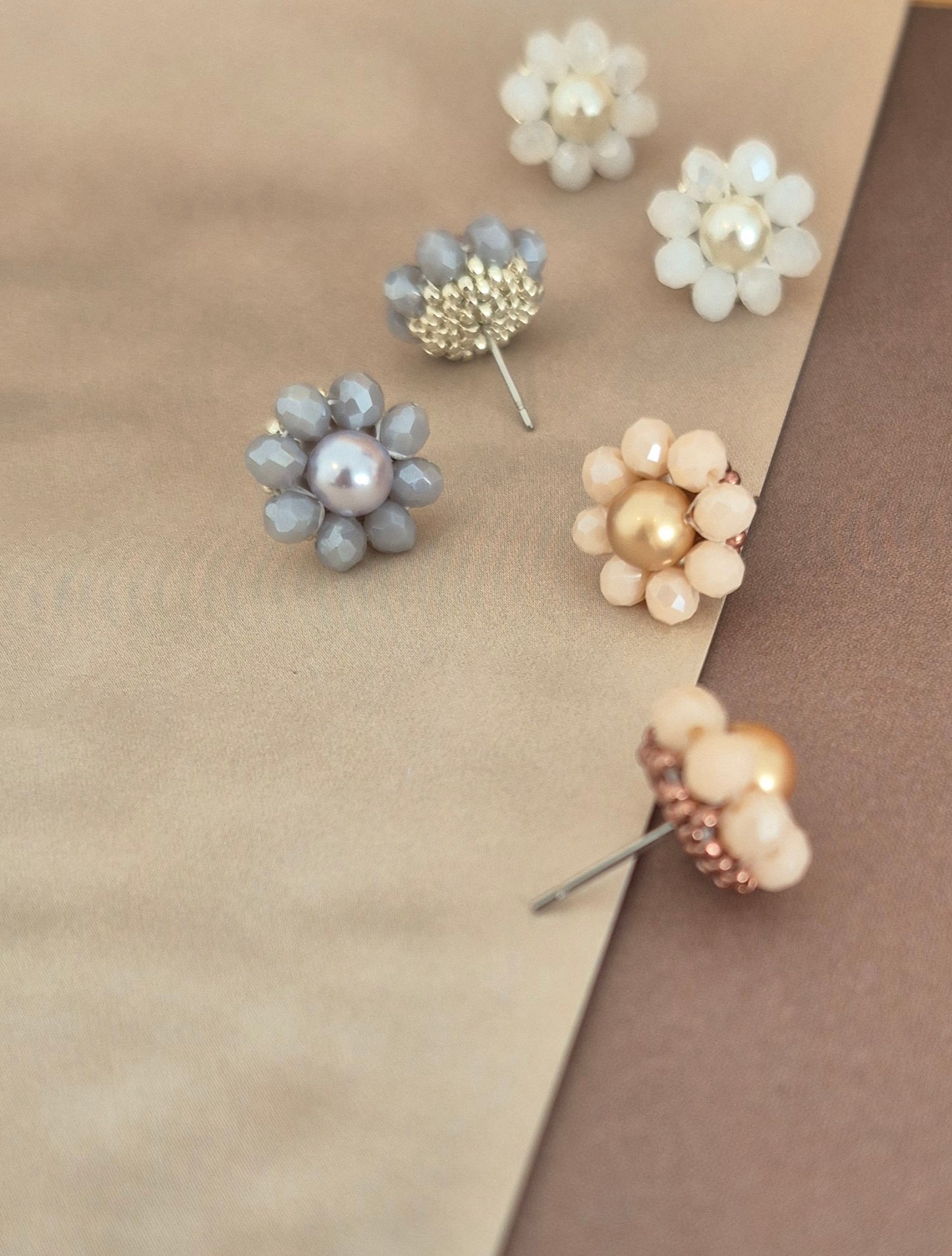 Elara Dusk - flower shaped stud earrings with glass beads and a pearl center