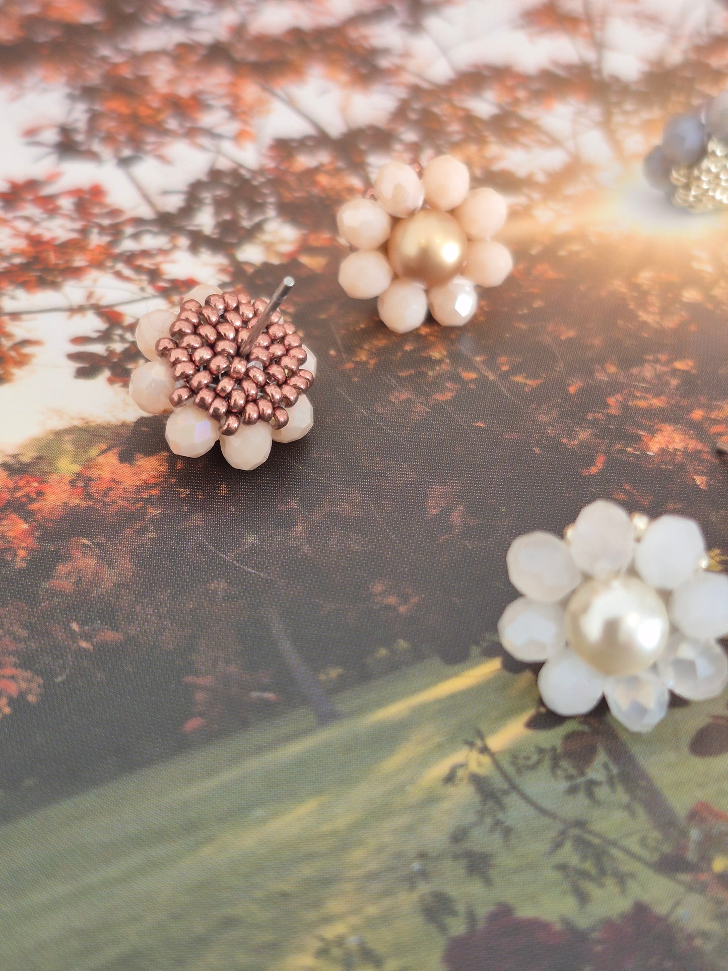 Elara Dusk - flower shaped stud earrings with glass beads and a pearl center