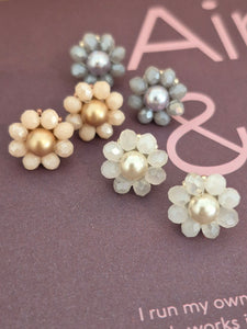 Elara Dusk - flower shaped stud earrings with glass beads and a pearl center