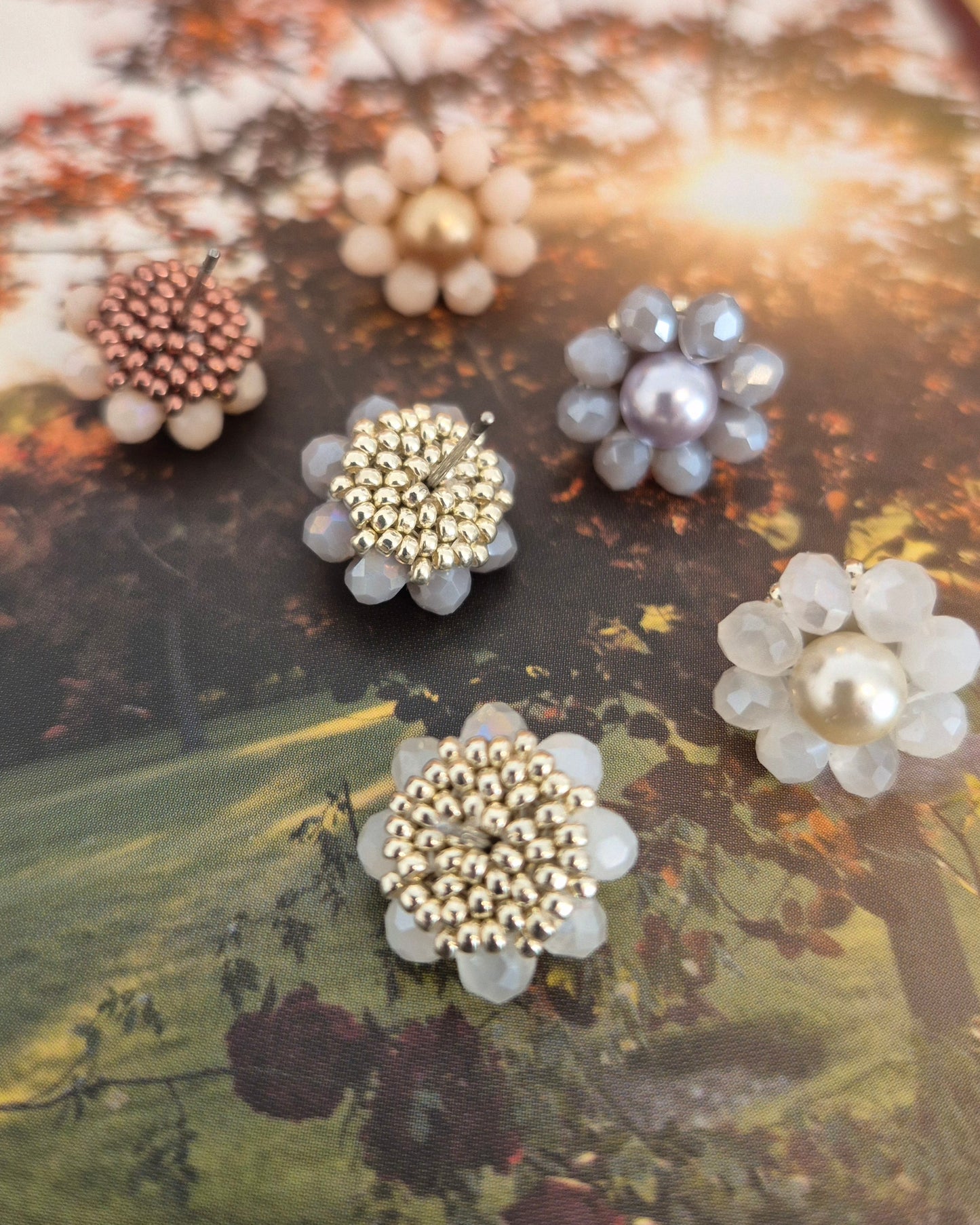 Elara Dusk - flower shaped stud earrings with glass beads and a pearl center