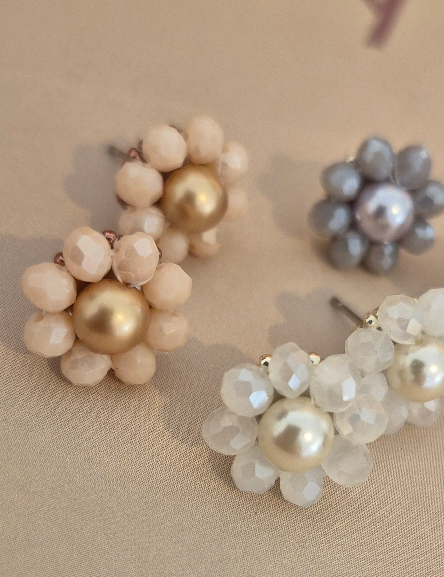 Elara Dusk - flower shaped stud earrings with glass beads and a pearl center