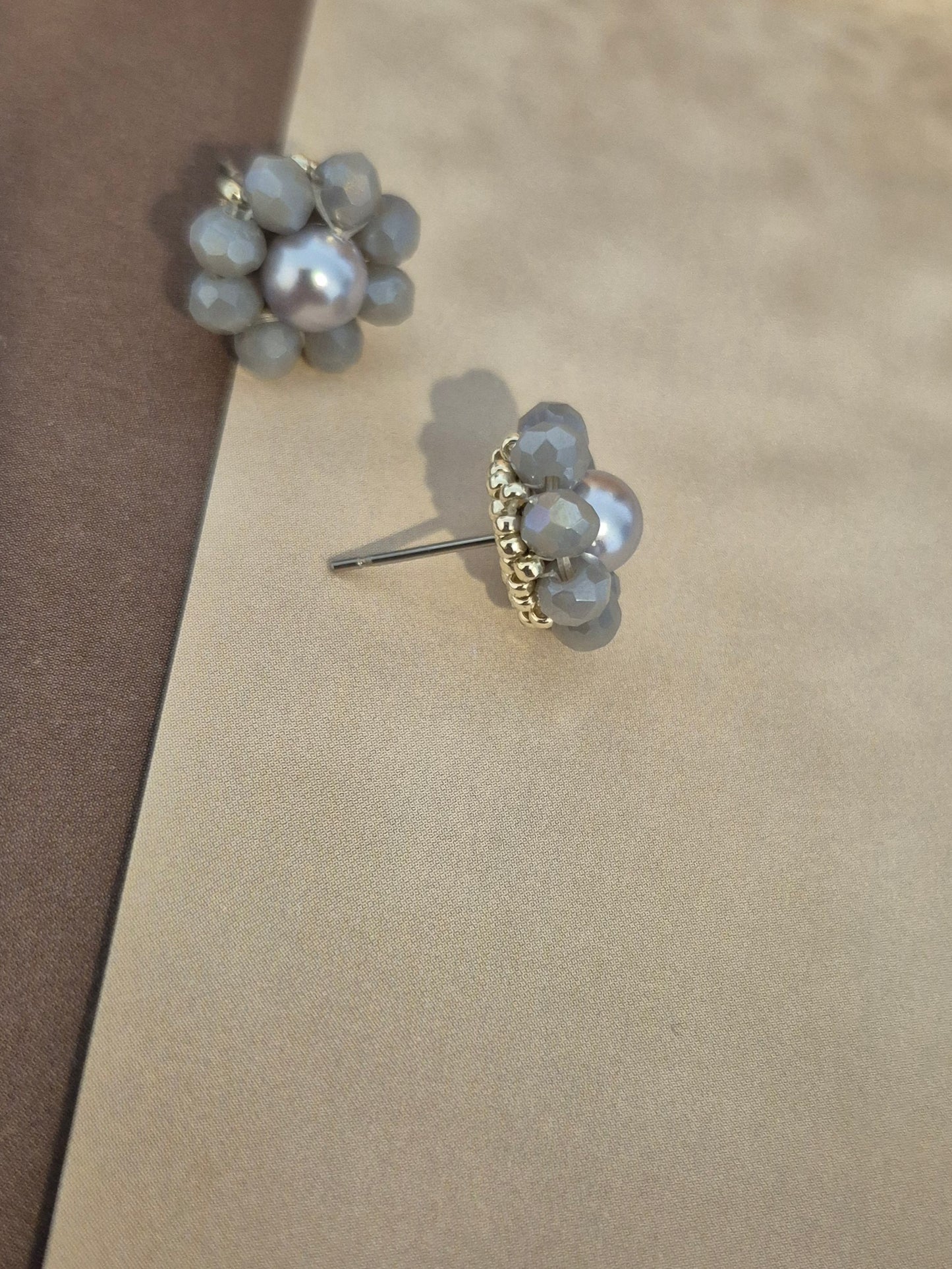 Elara Dusk - flower shaped stud earrings with glass beads and a pearl center