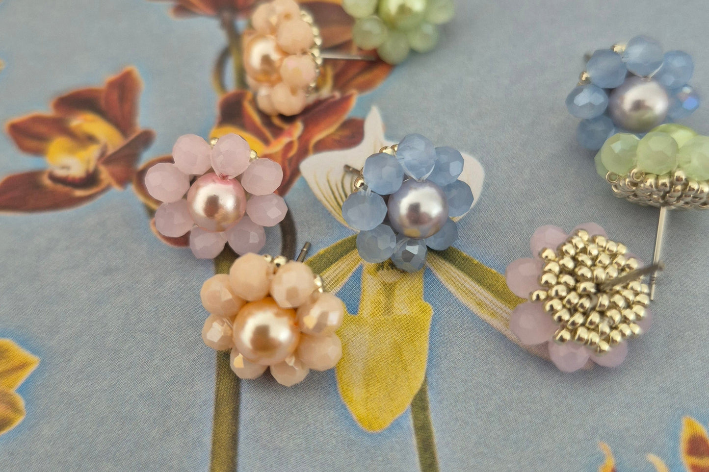 Close up of CrystalandCord pastel flower stud earrings