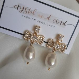 Swarovski crystal pearl drop and cubic zirconia bow gold-tone stud earrings