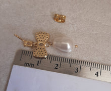 Load image into Gallery viewer, Swarovski crystal pearl drop and cubic zirconia bow gold-tone stud earrings