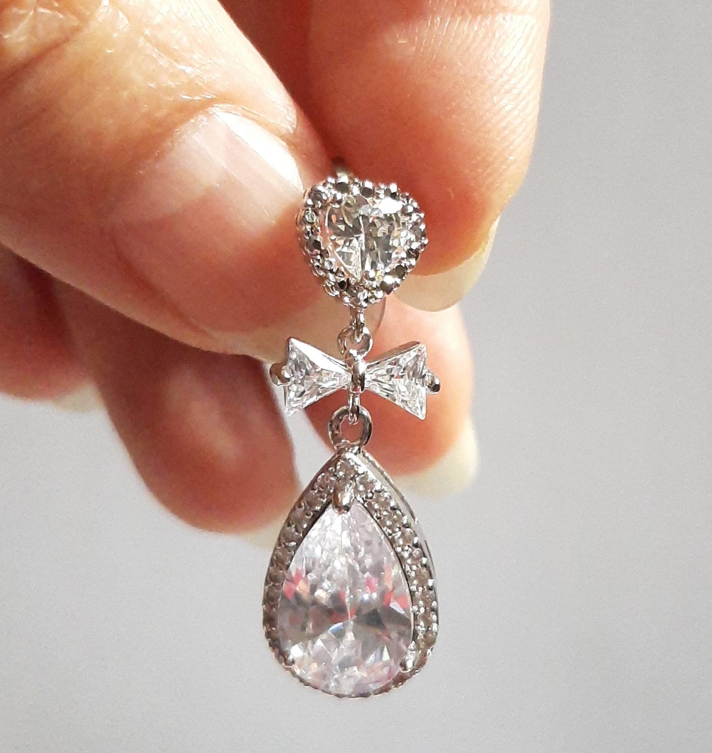 Yvette - Cubic Zirconia crystal clear heart, bow and pear shaped drop silver-tone stud earrings