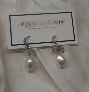 Stella - cultured freshwater pearl pear shaped drop earrings with cubic zirconia studded bow and earwires
