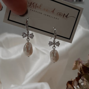 Stella - cultured freshwater pearl pear shaped drop earrings with cubic zirconia studded bow and earwires