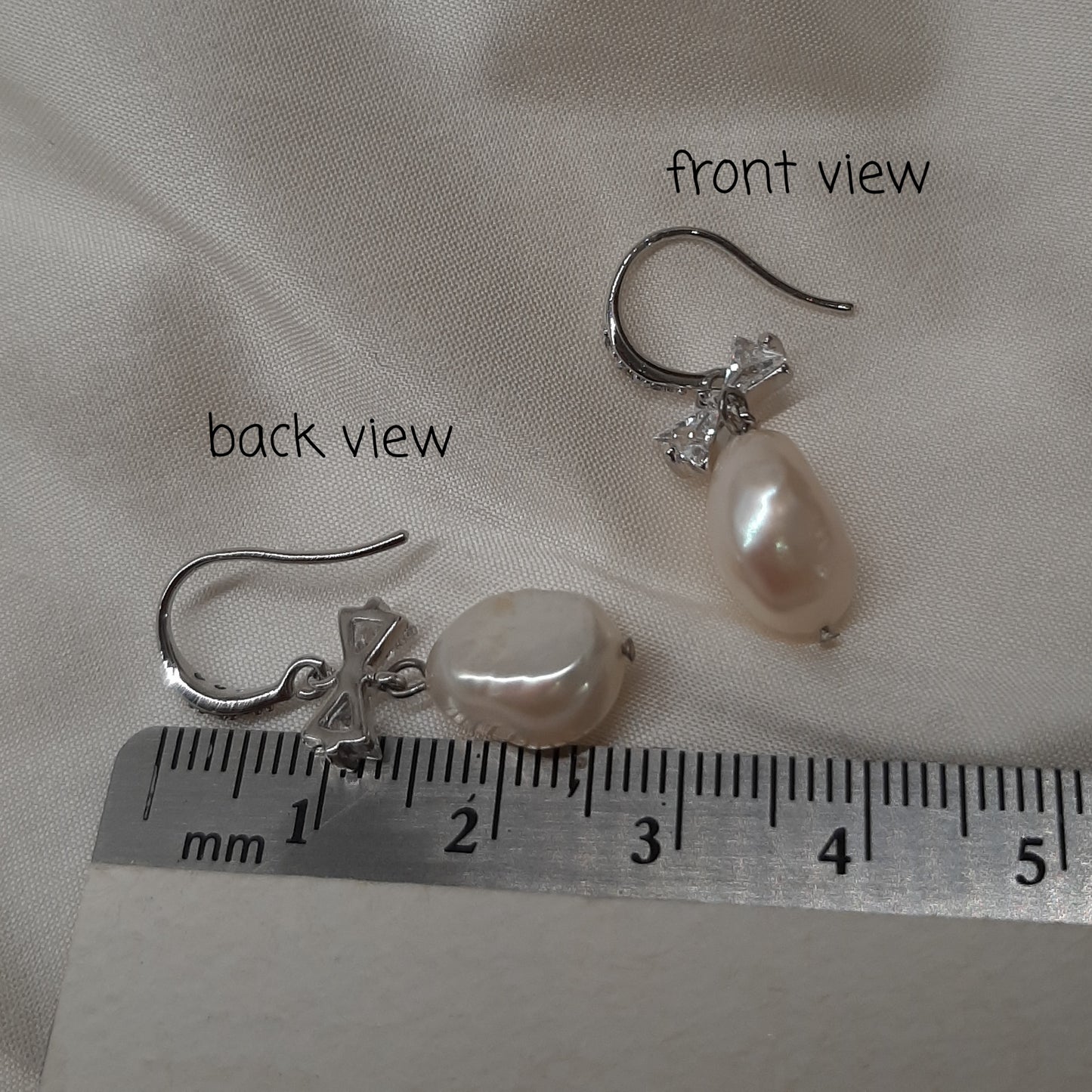 Stella - cultured freshwater pearl pear shaped drop earrings with cubic zirconia studded bow and earwires