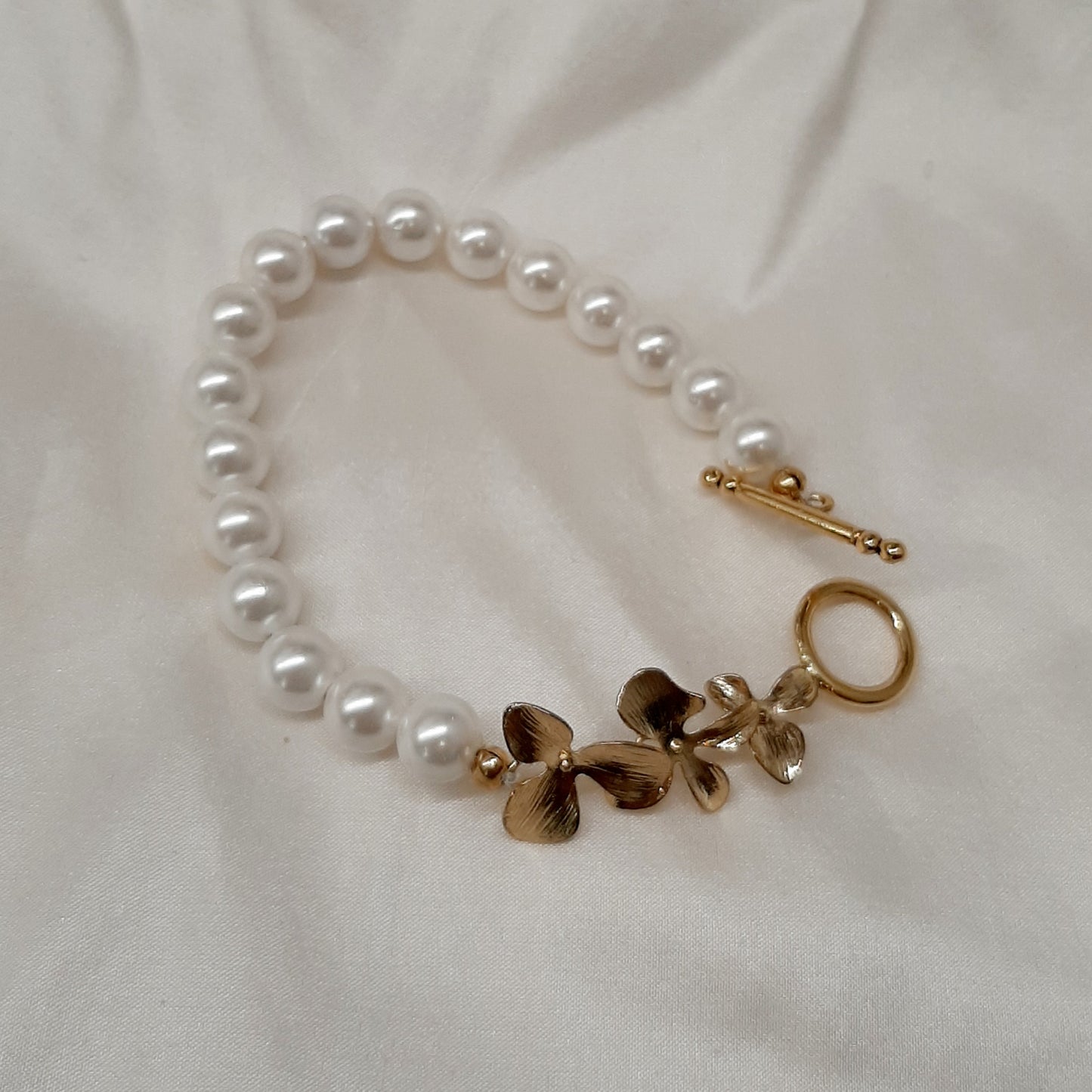 Clara - natural freshwater pearls or crystal based pearls and orchid shaped links bracelet with toggle clasp