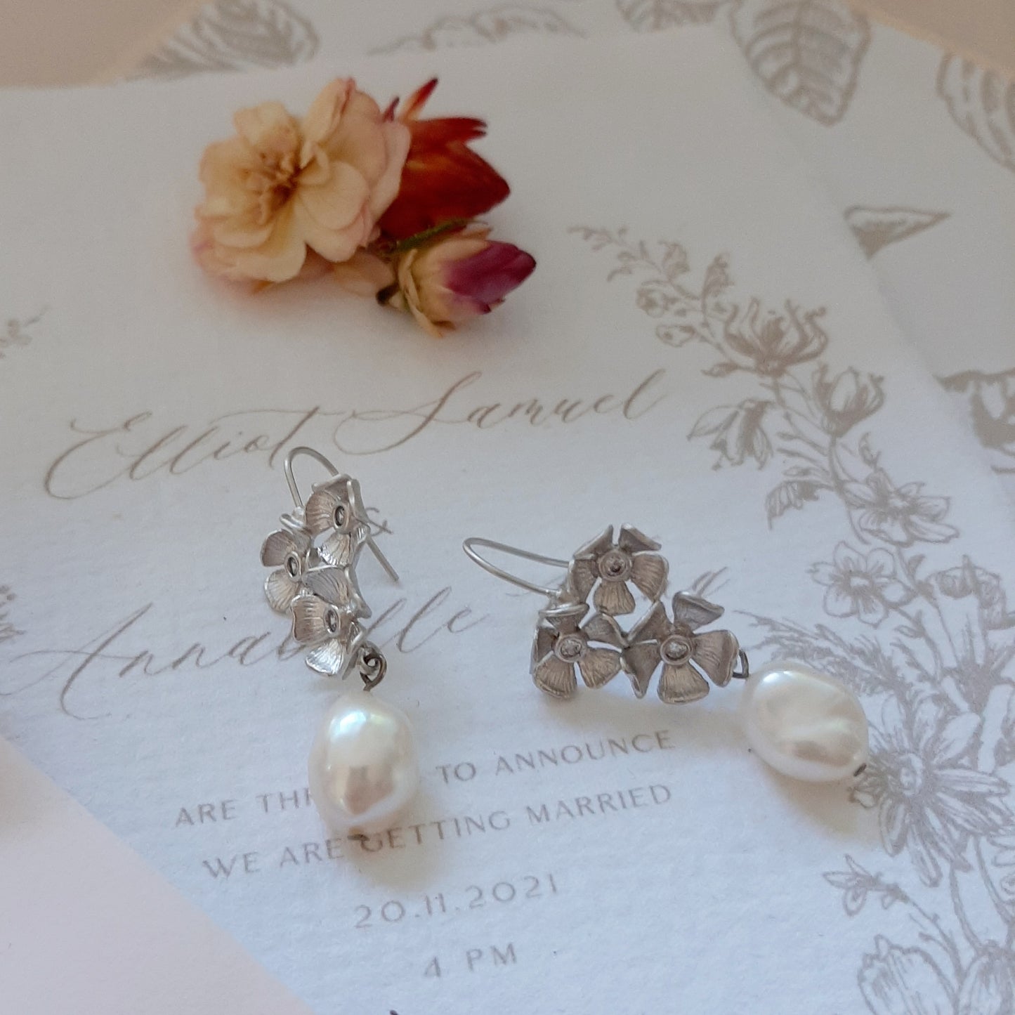 Maia - silver-tone triple flower rhinestone centered pearl drop earrings