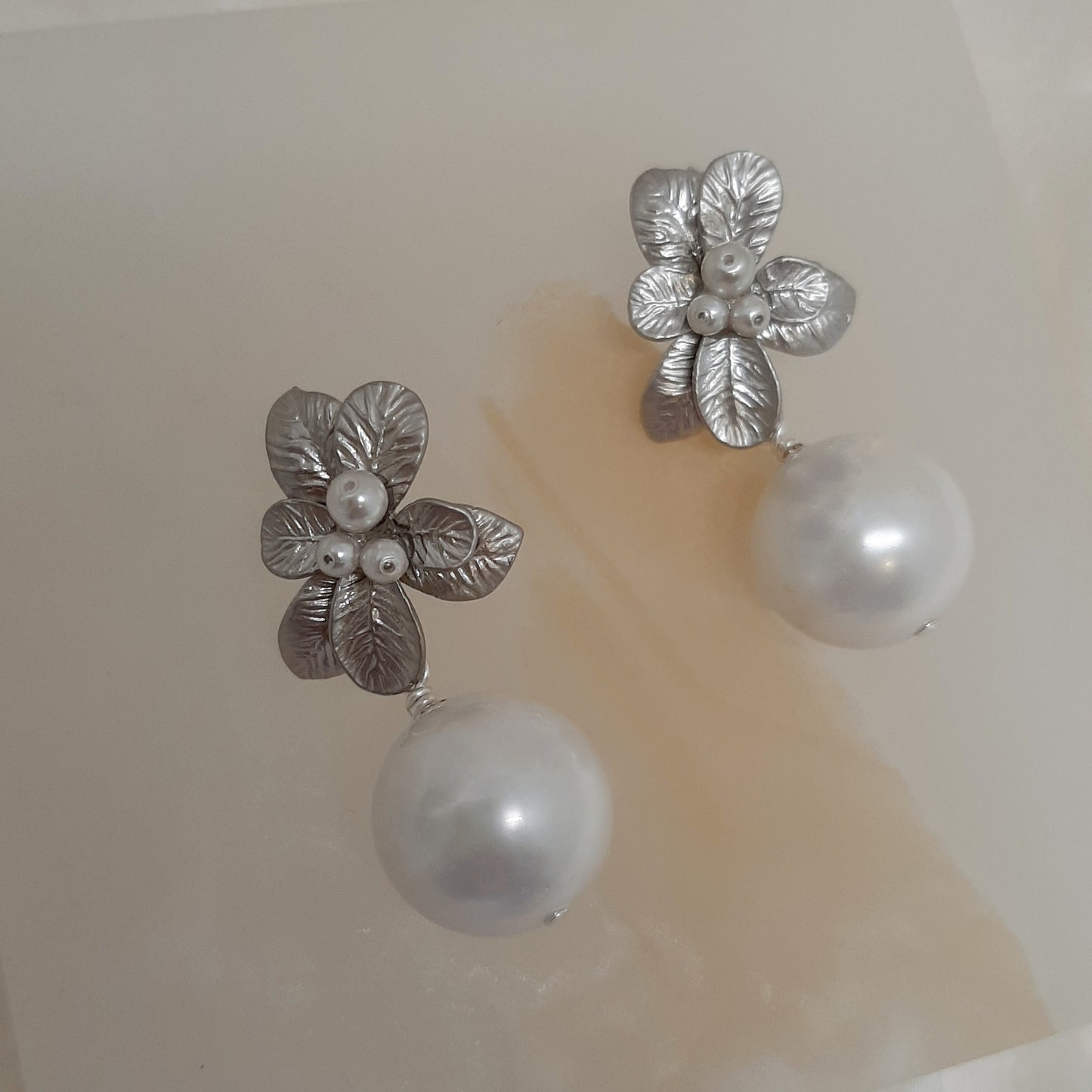 Marcy - faux pearl drop and silver-tone seven petal flower stud earrings