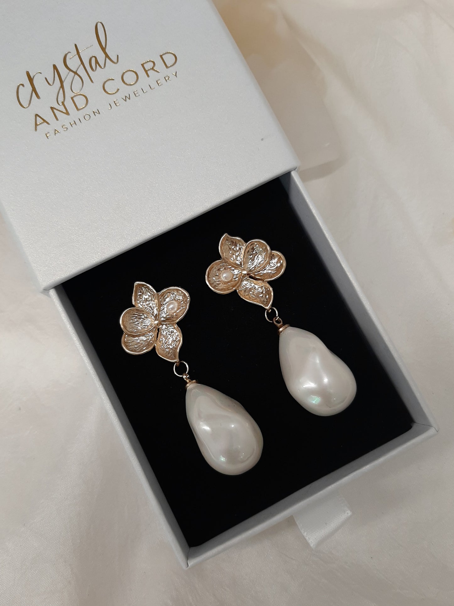 Monica - faux pearl drop and gold tone five petal flower stud earrings