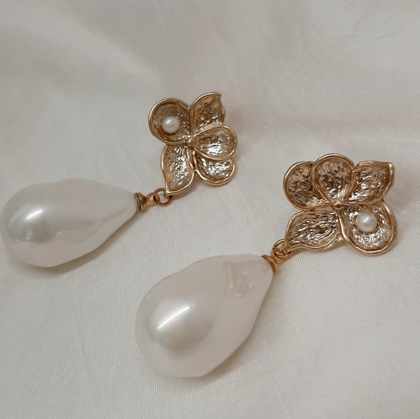 Monica - faux pearl drop and gold tone five petal flower stud earrings